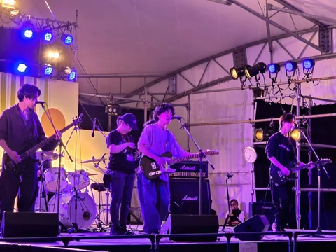 Band performing under stage lights