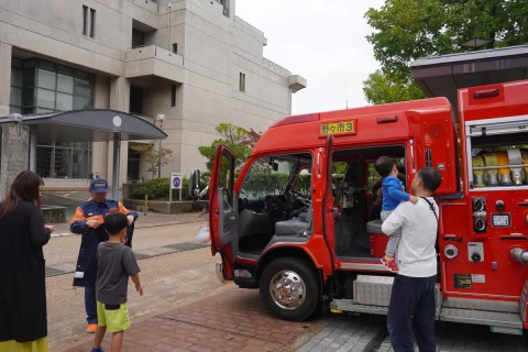 Parents and children exploring a fire engine