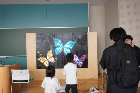 Visitors enjoying a colorful butterfly art exhibition