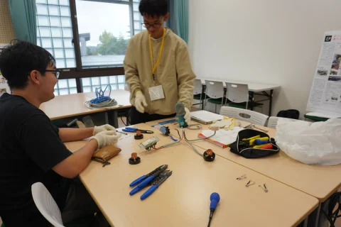 Workshop participants assembling wiring and electrical circuits