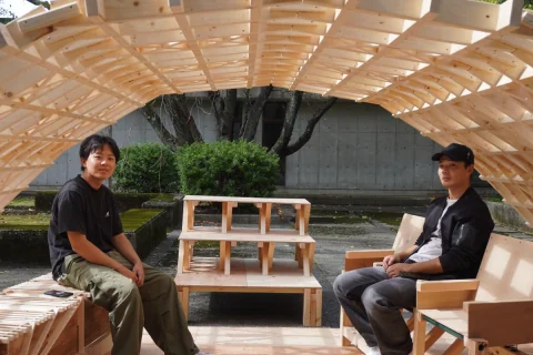 Students displaying a timber arch and handmade furniture