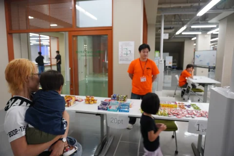 Visitors choosing prizes at an indoor festival booth