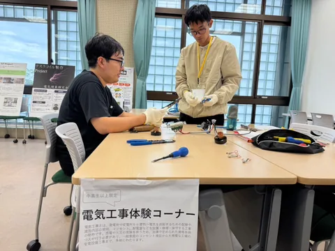 Students demonstrating an electrical wiring workshop
