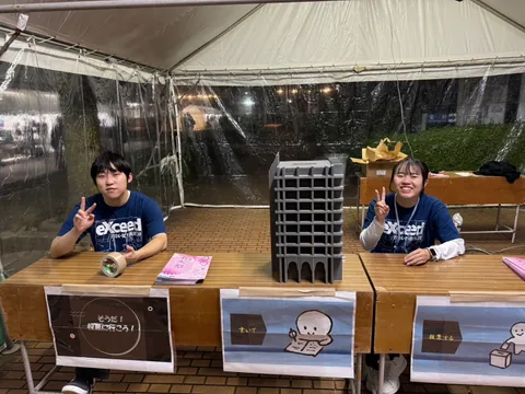 Two festival staff members at a voting booth