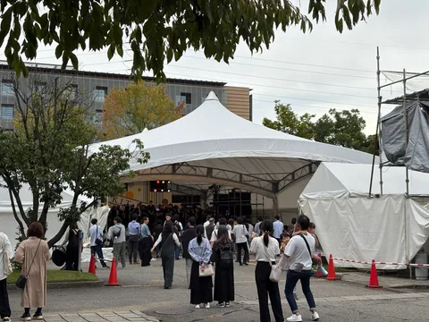 Visitors gathering outside the festival stage tent